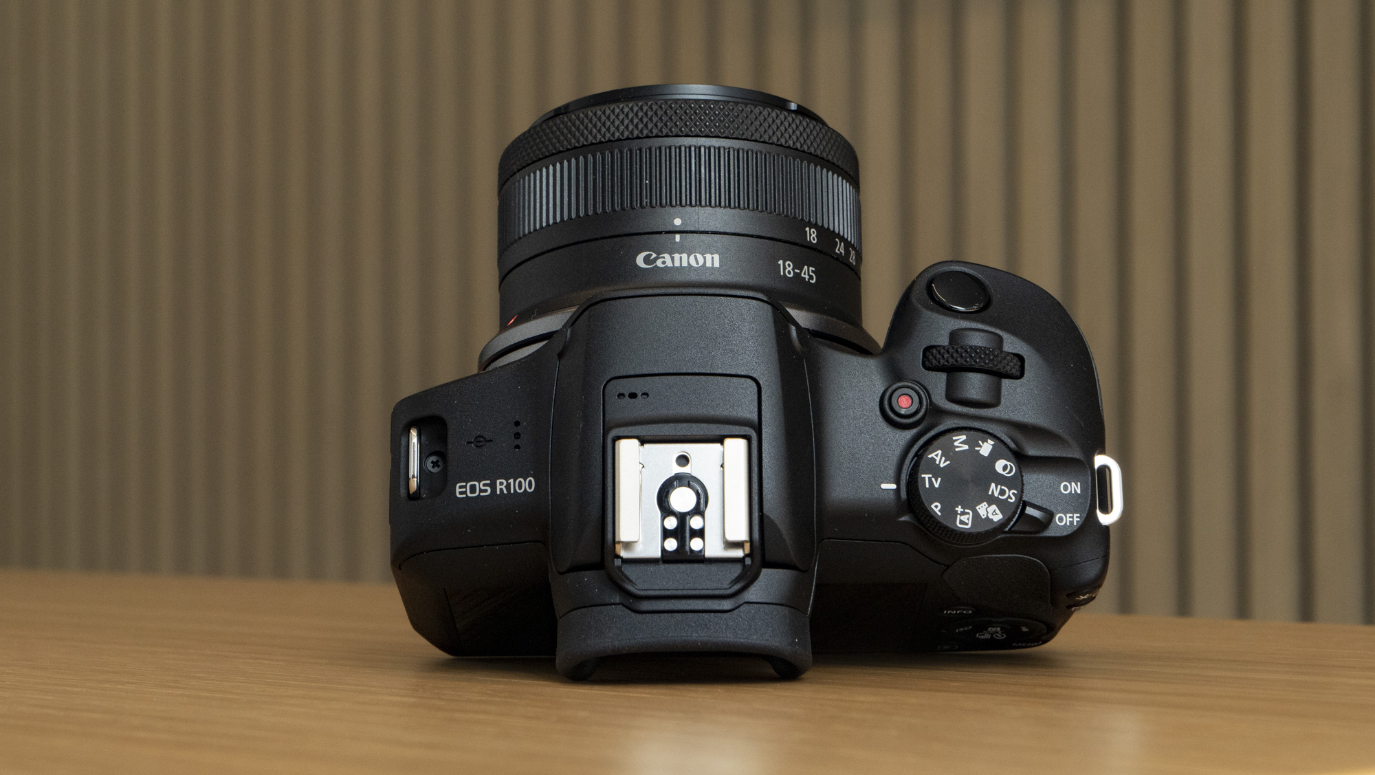 Canon EOS R100 camera on a table top plate