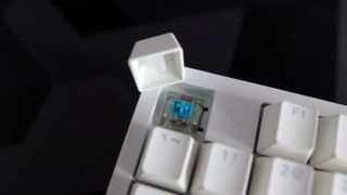 Ducky Zero 6108 gaming keyboard in white on a desk.