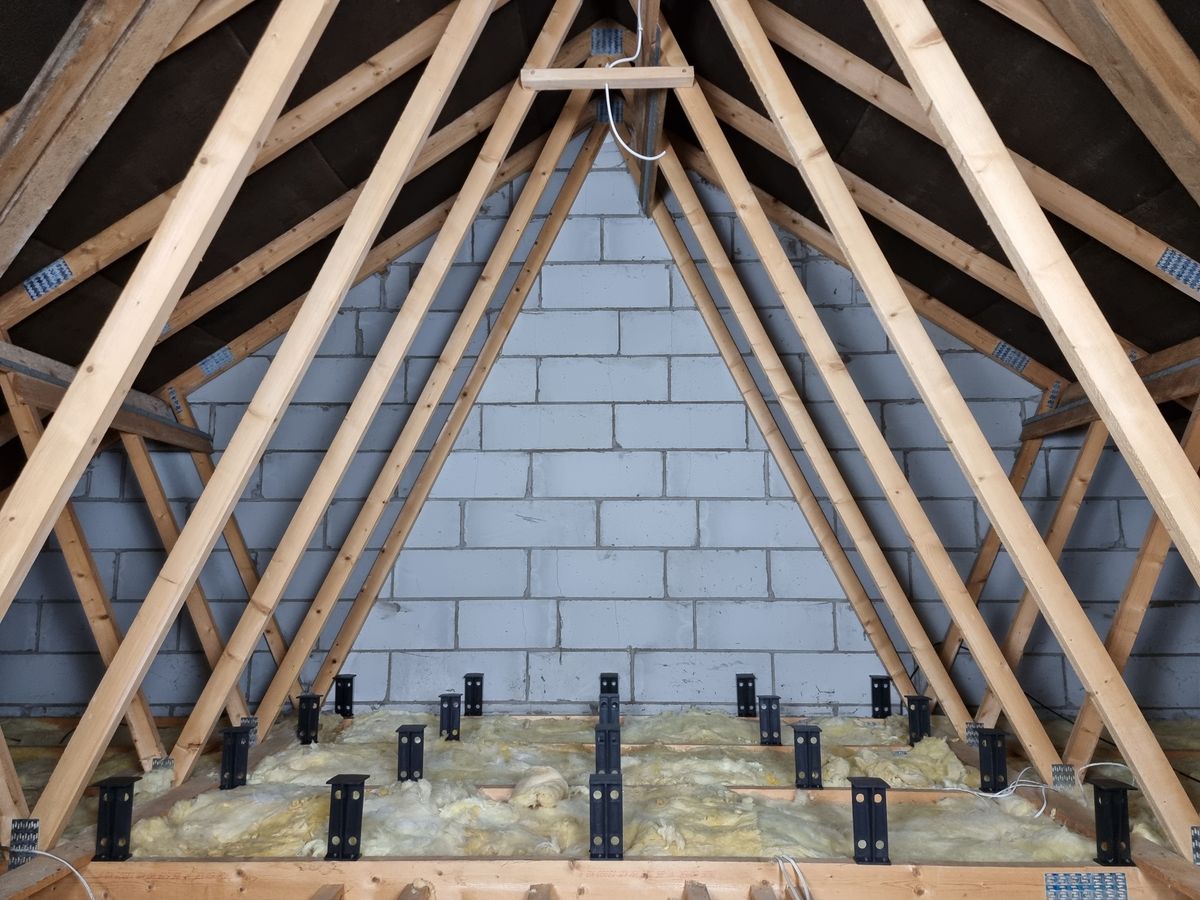Loft legs being used above loft insulation to raise the floor in an attic space