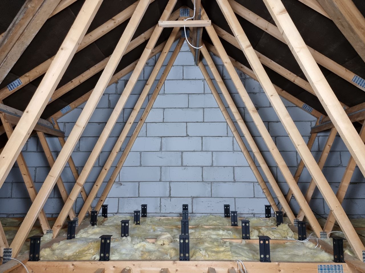 Loft legs being used above loft insulation to raise the floor in an attic space