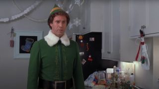Will Ferrell standing in the kitchen in his full elf outfit in Elf.