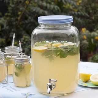 glass dispenser with lemonade in it