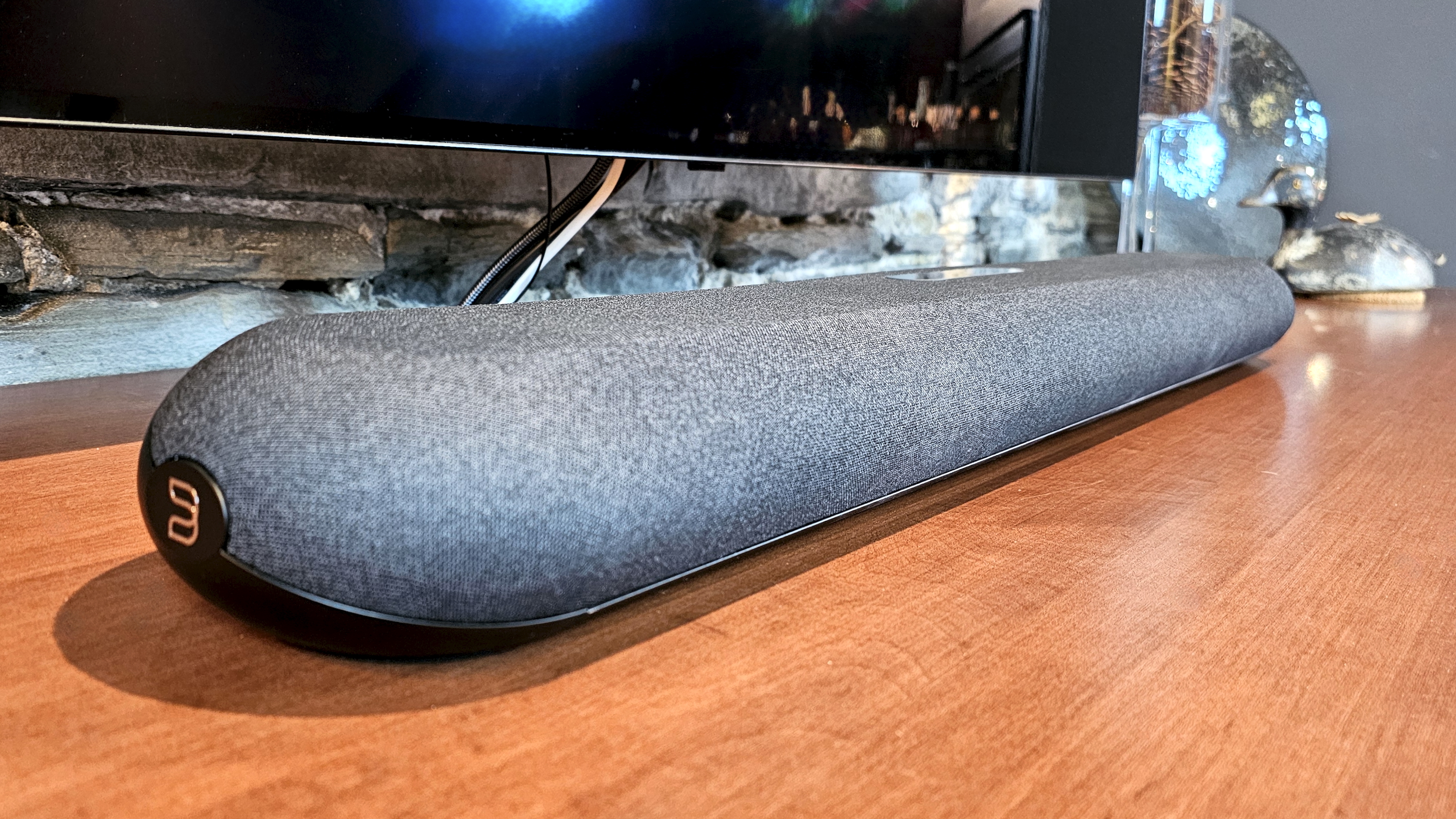 A close up of the Bluesound Pulse Mini soundbar on a wooden surface