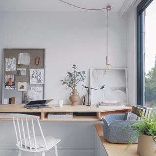 Home office with Scandi desk and hanging bare bulb pendant light.