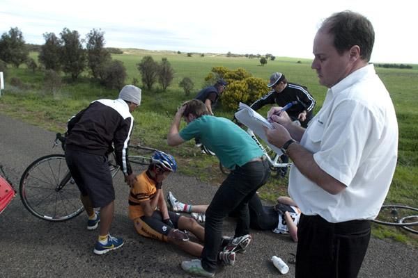 Gee these pens are hopeless: Commissaire Matthew Wright jots down the riders details after another crash on stage eleven.
