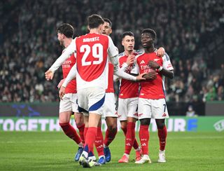 Kai Havertz of Arsenal celebrates scoring his team's second goal with teammates William Saliba, Gabriel Martinelli and Bukayo Saka during the UEFA Champions League 2024/25 League Phase MD5 match between Sporting Clube de Portugal and Arsenal FC at Estadio Jose Alvalade on November 26, 2024 in Lisbon, Portugal.