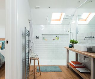 loft conversion bathroom with white walls and tiles, walk in shower, long vanity unit and wooden flooring