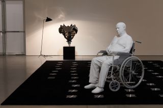 Installation view of Elmgreen & Dragset's solo exhibition at Pace New York, 'The Nervous System'. Featuring 'A Day Short of a Year' rug, 'Tailbone (Stainless Steel)' Sculpture and 'Bogdan' sculpture