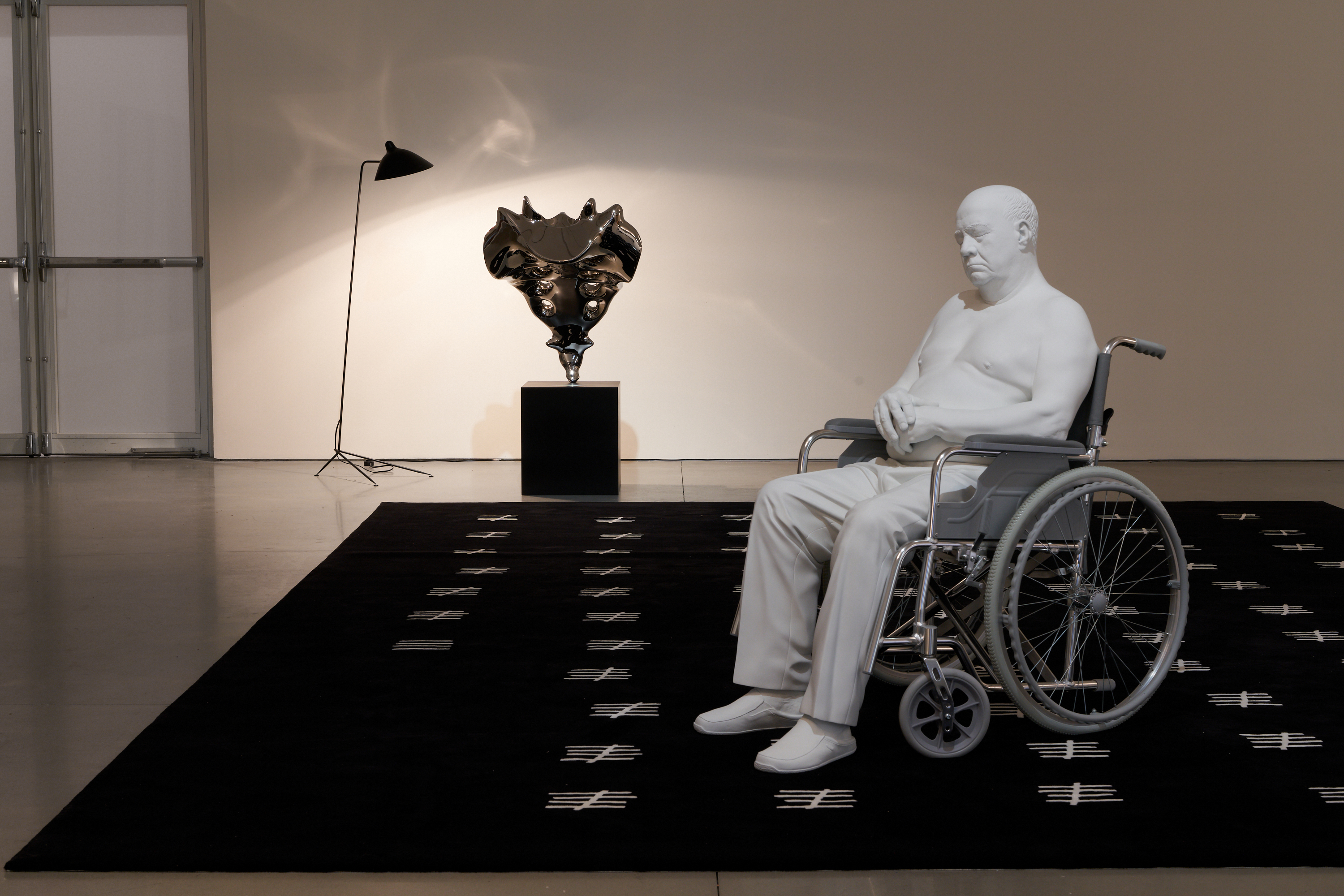 Installation view of Elmgreen & Dragset's solo exhibition at Pace New York, 'The Nervous System'. Featuring 'A Day Short of a Year' rug, 'Tailbone (Stainless Steel)' Sculpture and 'Bogdan' sculpture