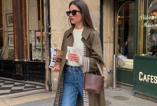 French woman in a trench coat and jeans