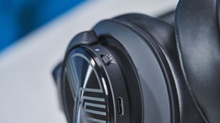 A black Treblab Z2 over-hear headset with a gray logo on each earcup