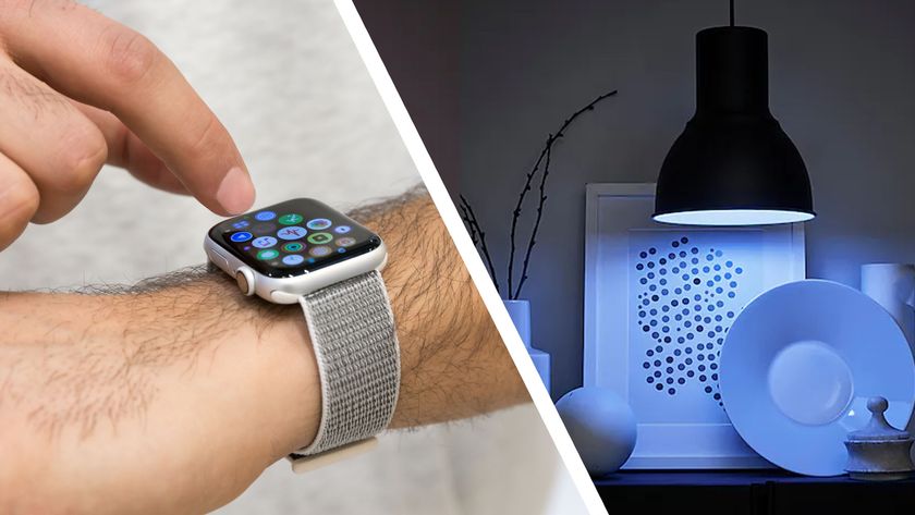 Person using Apple Watch on wrist beside shelf illuminated by blue IKEA smart light