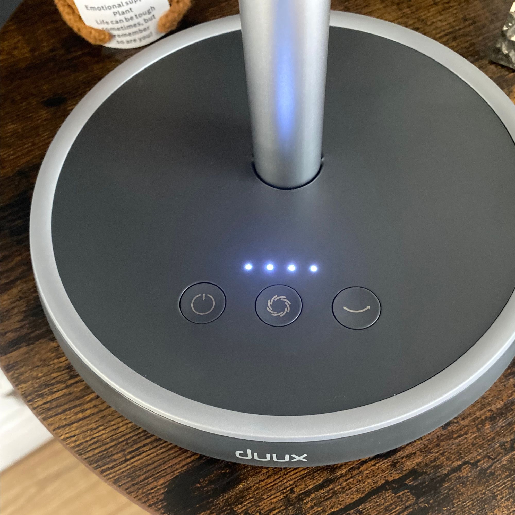 Four illuminated lights on the control panel of the Duux Rize fan