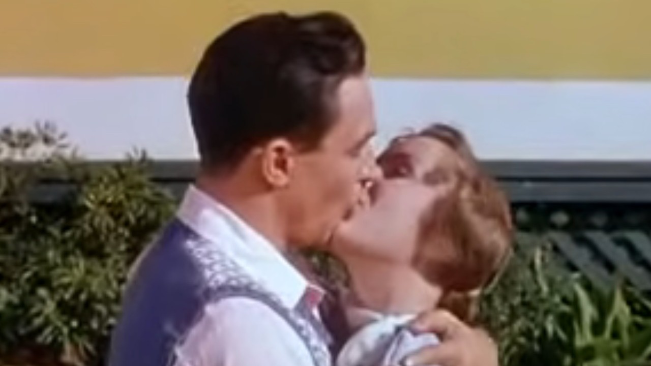 Gene Kelly kissing Debbie Reynolds in Singin' in the Rain