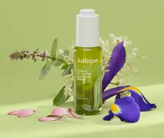 Jurlique recovery serum surrounded by flowers
