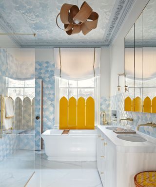 Modern bathroom with freestanding bathtub and wallpaper cloud ceiling