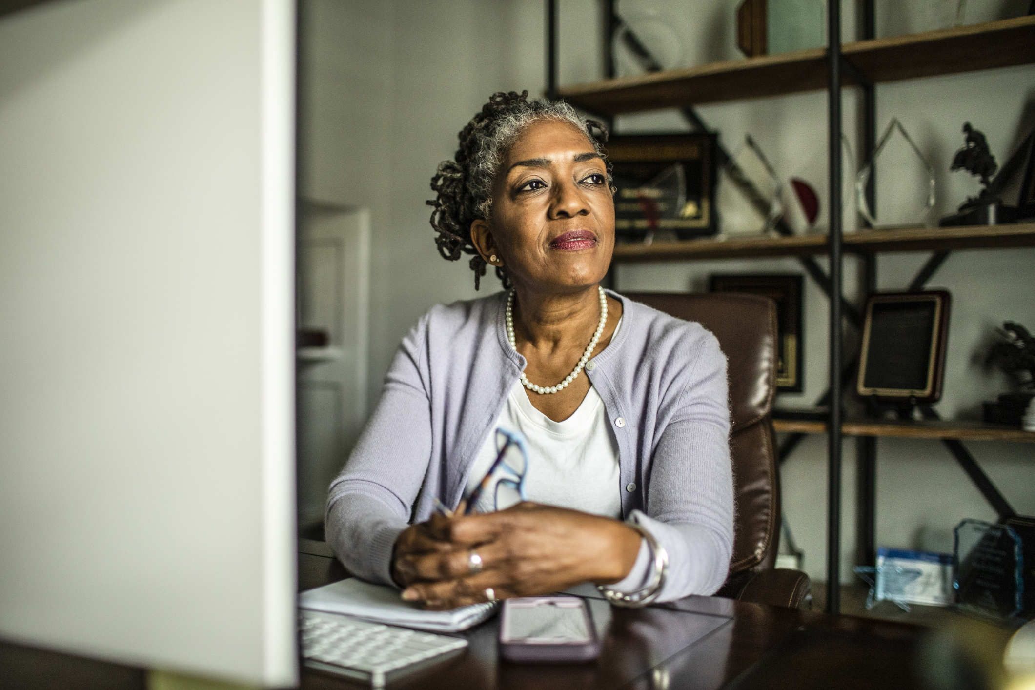 State pensioner on a computer reviewing her finances