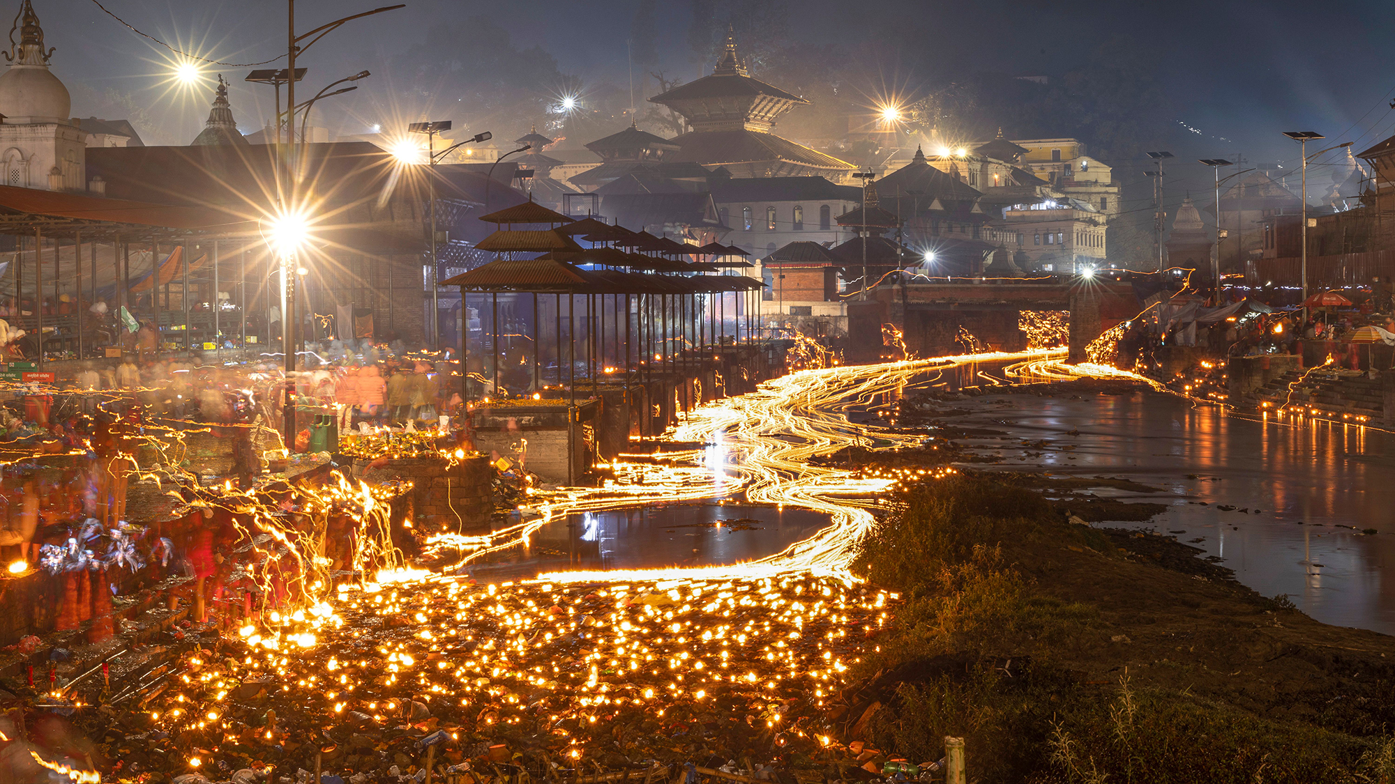 Devotees release oil lamps into the river during the Bala Chaturdashi Festival in Kathmandu, Nepal