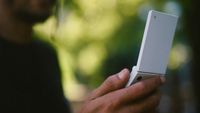 The Light Flip phone held in a person's hand