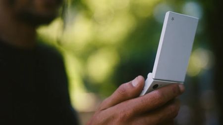 The Light Flip phone held in a person's hand