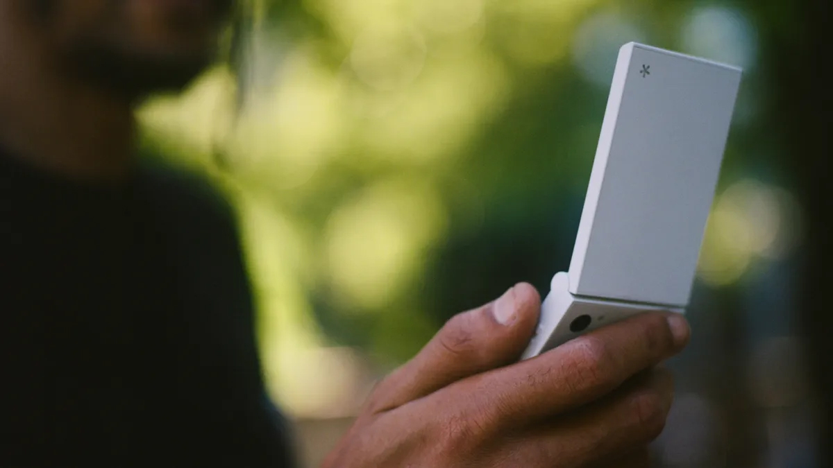 The Light Flip phone held in a person's hand