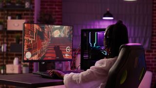 black woman playing game on desktop gaming pc