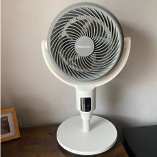 Pro Breeze Airflo 43'' Hybrid Pedestal Fan in desktop configuration on a side table against a taupe wall
