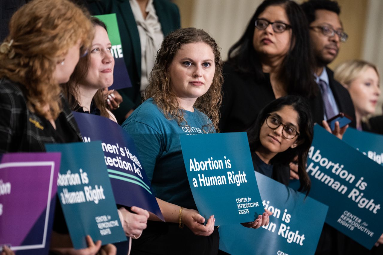 Woman holding sign