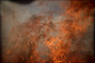 Flames from a brush fire are clearly visible this this final image from a remote camera set up by NASA photographer Bill Ingalls for SpaceX's Falcon 9 rocket launch on May 22, 2018. The brush fire ultimately melted the camera, but its memory card was still accessible.