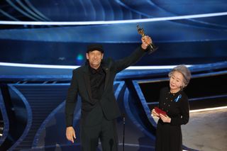 Troy Kotsur accepts the Actor in a Supporting Role award for CODA from Youn Yuh-jung during the show at the 94th Academy Awards at the Dolby Theatre at Ovation Hollywood on Sunday, March 27, 2022.