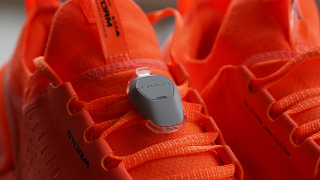 Coros Pod 2 review: Pictured here, the Coros Pod 2 clipped onto a pair of orange running shoes