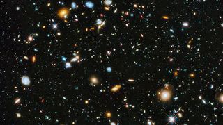 a distant view of many galaxies against black space