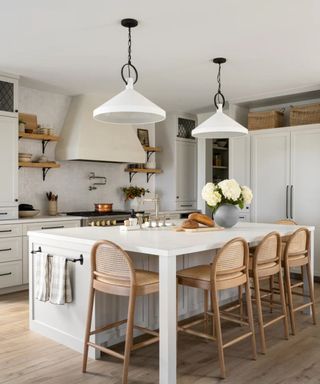 a white kitchen with iron hardware