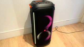 JBL Partybox 710 review: speaker with lights on a wooden floor