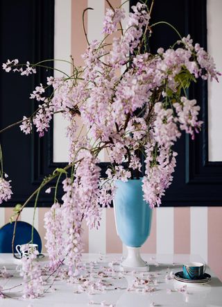 cherry blossom in a tall blue vase