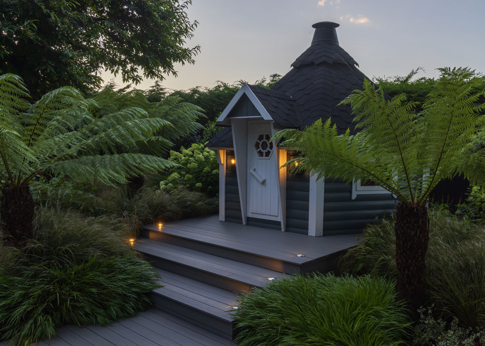 garden room with lighting, garden steps and planting