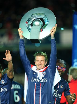 Beckham lifts the Ligue 1 trophy (PA).