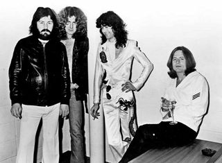 Led Zeppelin posing backstage