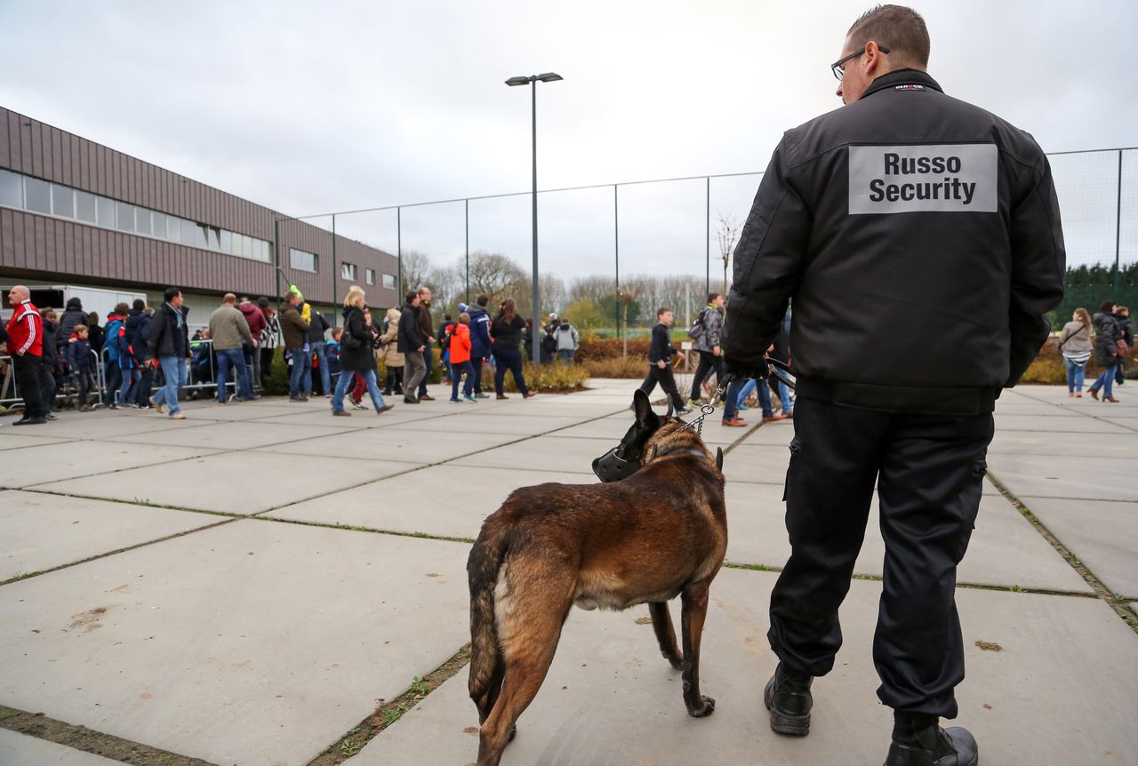 A Belgian police officer patrols as supporters arrive to attend a training session of the Belgian national football team in Brussels