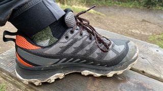 Person's foot wearing Merrell Speed Eco Waterproof hiking shoe
