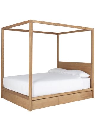 Wooden 4 poster storage bed with white bedding and 2 white pillows
