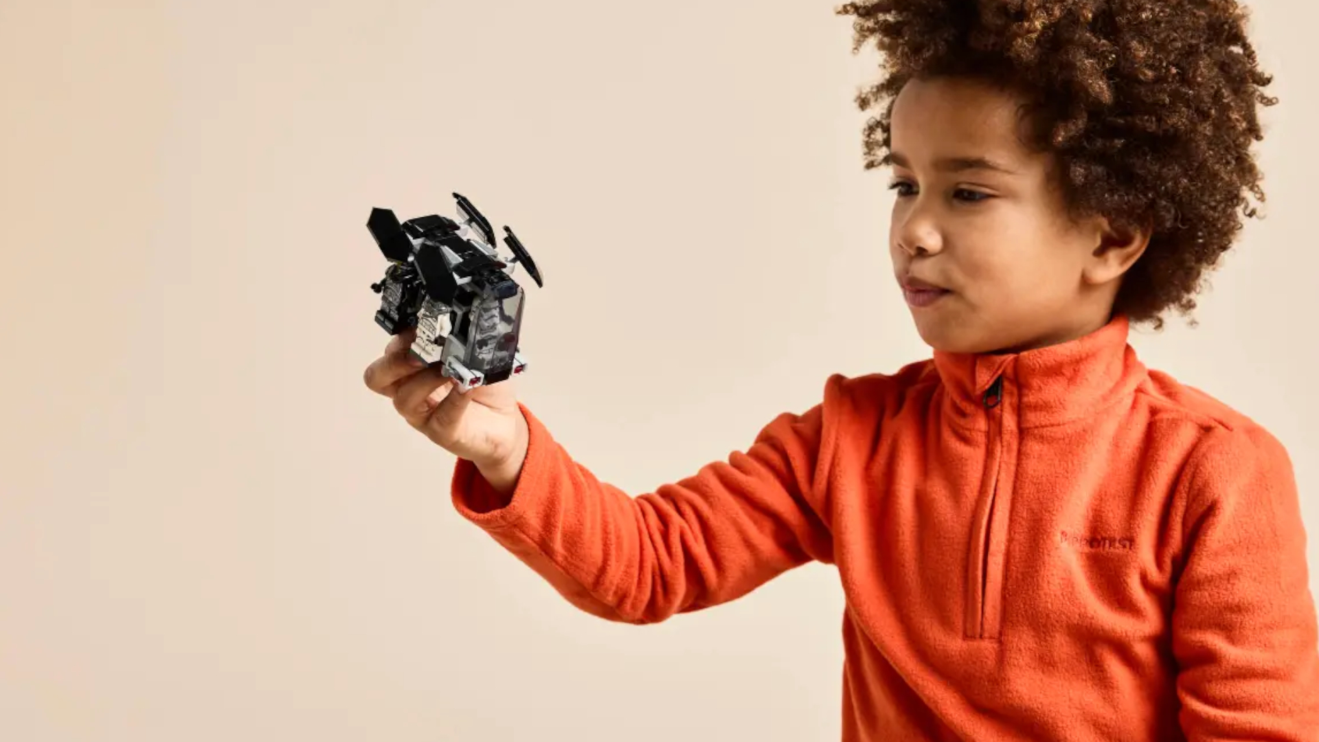 A child holds the Lego Death Trooper & Night Trooper transport model