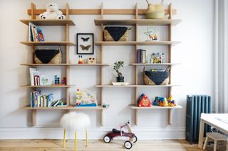 A kids playroom with wall storage displaying baskets
