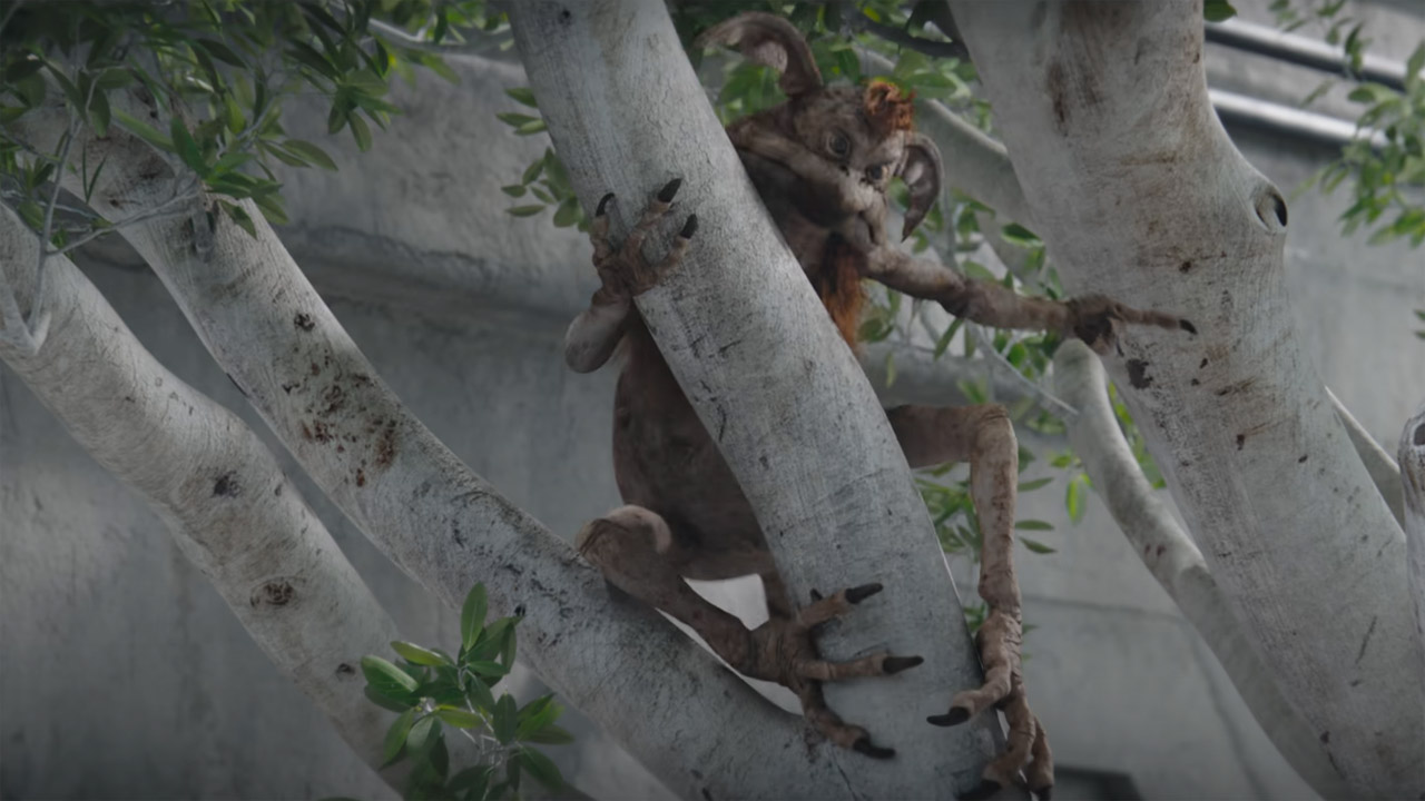 A Kowakian points at someone as he sits in a tree in The Mandalorian season 3