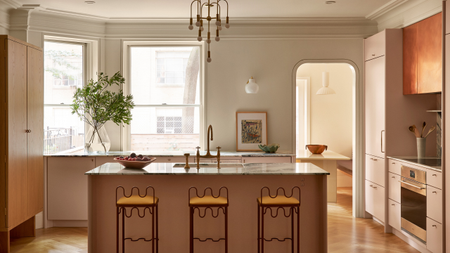 large period kitchen with curved metal stools and dusty pink cabinets