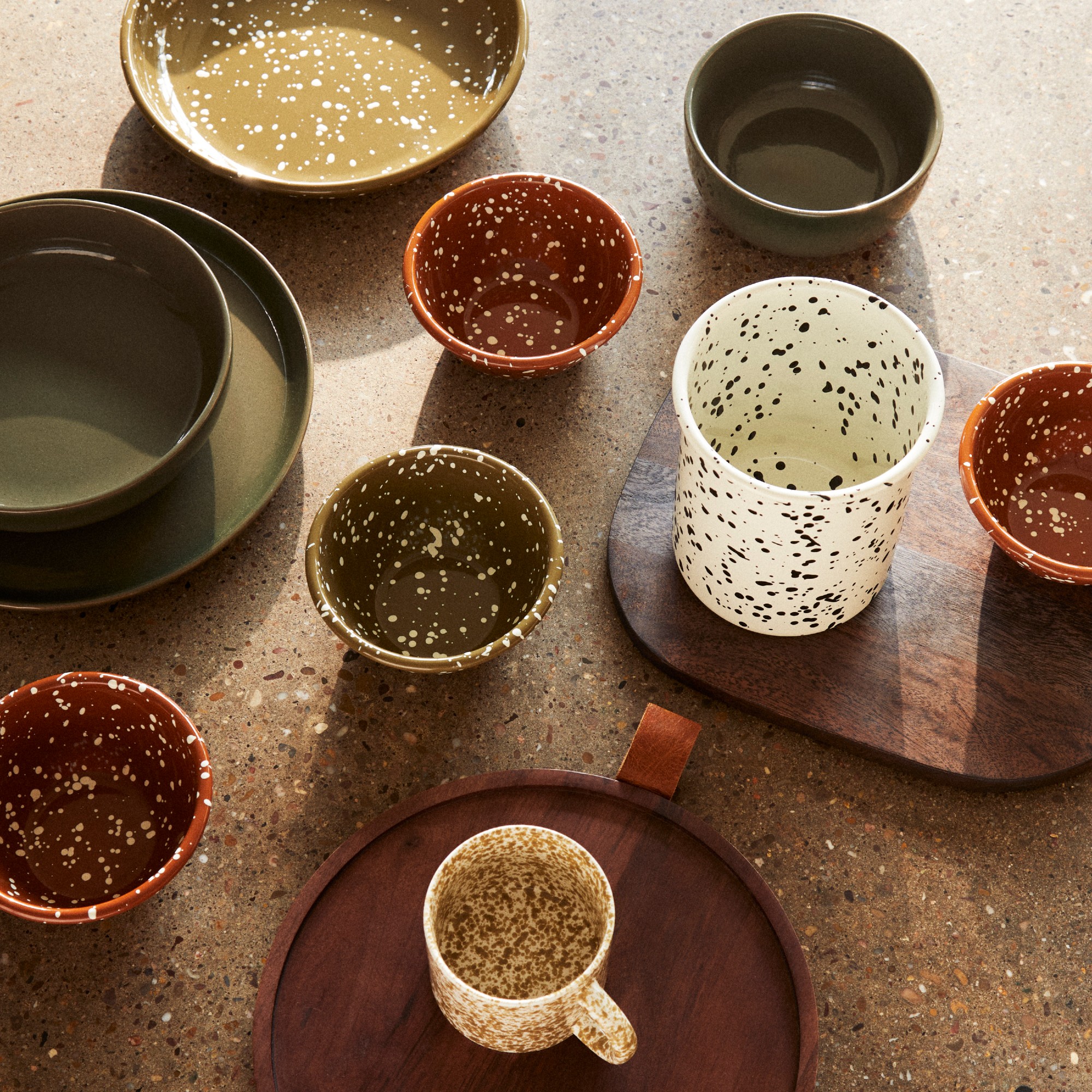Splatter-design enamel bowls and on terrazzo worktop