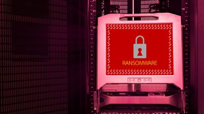 The word 'RANSOMWARE' on a red background beneath a white padlock and surrounded by dollar signs, displayed on a monitor inside a data center.