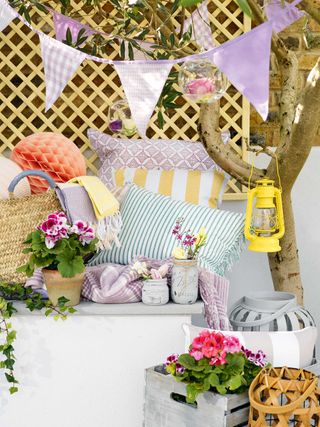 garden decor ideas: bunting and cushions in bright colors