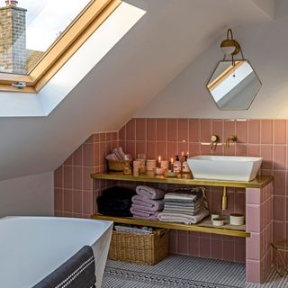 Attic bathroom with pink tiles on wall behind sink