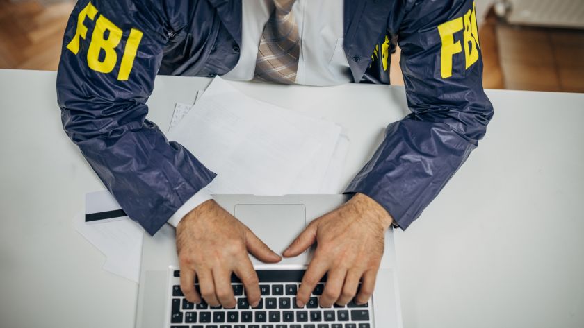 An FBI agent typing on a computer